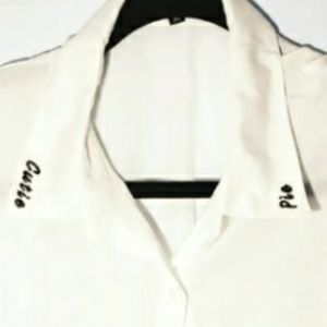 Tall white button up with cutie pie embroidered on the collar tips.